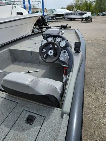 Slide: The Image of 2016 Tracker Pro Team™ 175 TXW boat with trolling motor in a parking area. - 5