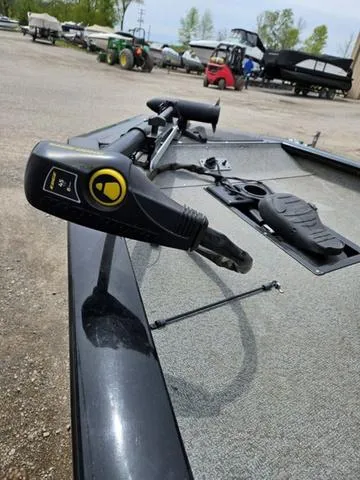 Slide: The Image of 2016 Tracker Pro Team™ 175 TXW boat with trolling motor in a parking area. - 6