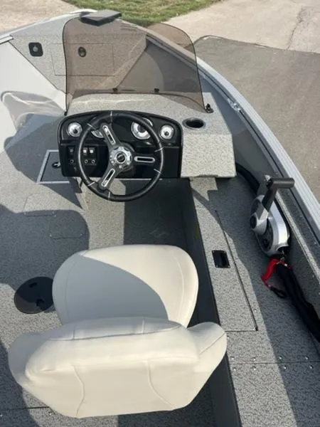 Slide: The Image of 2024 Smoker Craft Freedom 180 SC boat interior with steering wheel and seat. - 3