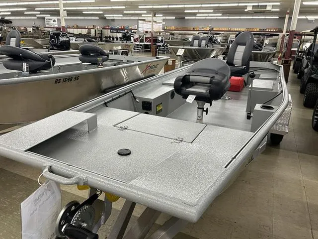 Slide: The Image of 2025 XTREME BOATS River Skiff 1542SS displayed in showroom, featuring sleek design and seating. - 2