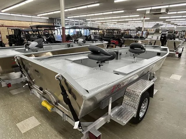 Slide: The Image of 2025 XTREME BOATS Brute 1754SS Tunnel displayed in showroom, featuring sleek design and seating. - 8