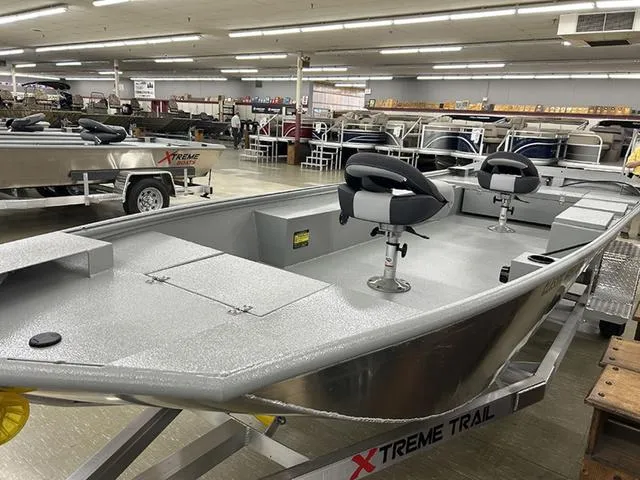 Slide: The Image of 2025 XTREME BOATS Classic 1854SS Tunnel displayed in showroom with seating and storage features. - 2