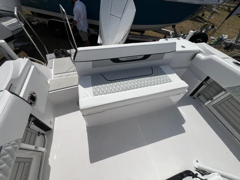 Slide: The Image of 2025 Blackfin 222 CC boat interior with white seating and modern design. - 5