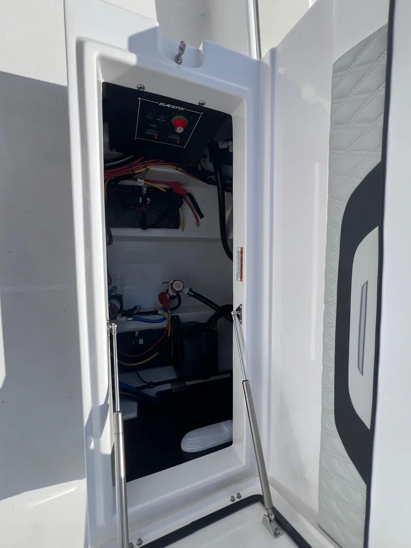 Slide: The Image of 2025 Blackfin 222 CC boat interior compartment with wiring and control panel. - 6