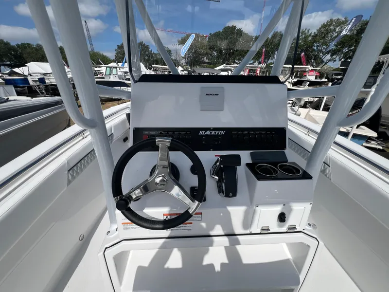 Slide: The Image of 2025 Blackfin 222 CC boat console with steering wheel and controls. - 8