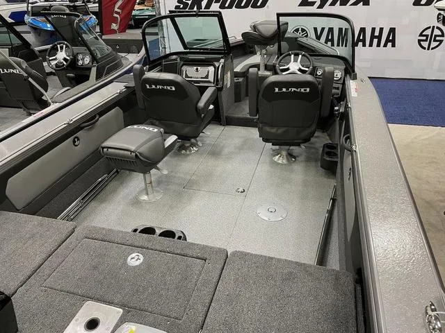 Slide: The Image of 2025 Lund 1975 Tyee Sport boat interior with seating and steering console. - 3