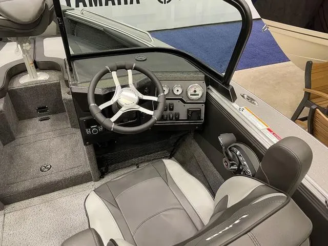 Slide: The Image of Interior of 2025 Lund 1975 Tyee Sport boat, featuring steering wheel and dashboard controls. - 4