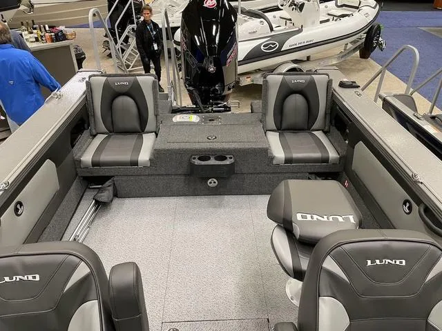 Slide: The Image of 2025 Lund 1975 Tyee Sport boat interior with gray seating and modern design. - 7