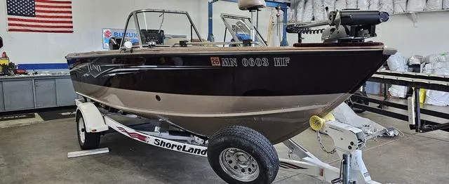 Slide: The Image of 1996 Lund 1950 Tyee boat on ShoreLand'r trailer in a garage setting. - 5