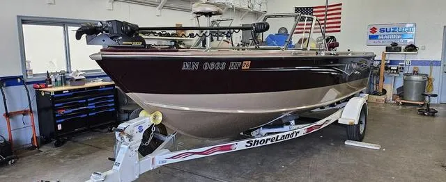 Slide: The Image of 1996 Lund 1950 Tyee boat on ShoreLand'r trailer in a garage setting. - 6