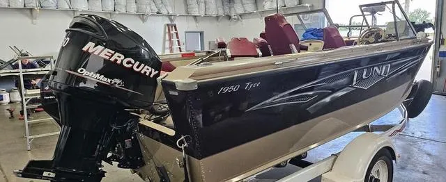 Slide: The Image of 1996 Lund 1950 Tyee boat with Mercury OptiMax engine in a garage setting. - 7