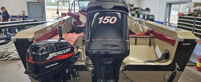 Slide: The Image of 1996 Lund 1950 Tyee boat with Mercury outboard motors in a workshop setting. - 8