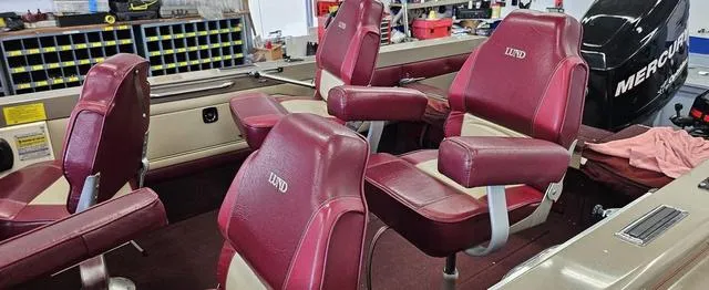 Slide: The Image of Red interior seats of a 1996 Lund 1950 Tyee boat with a Mercury engine. - 9