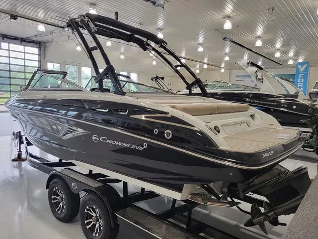 Slide: The Image of 2022 Crownline 240 SS SURF boat displayed indoors on a trailer. - 3