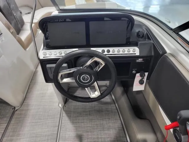 Slide: The Image of 2022 Crownline 240 SS SURF boat dashboard with steering wheel and control panel. - 6