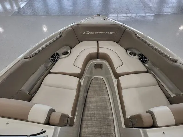 Slide: The Image of 2022 Crownline 240 SS SURF boat interior with cushioned seating and speakers. - 8