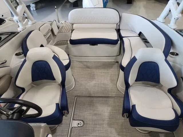 Slide: The Image of 2024 Crownline E260 XS boat interior with plush seating and modern design. - 6