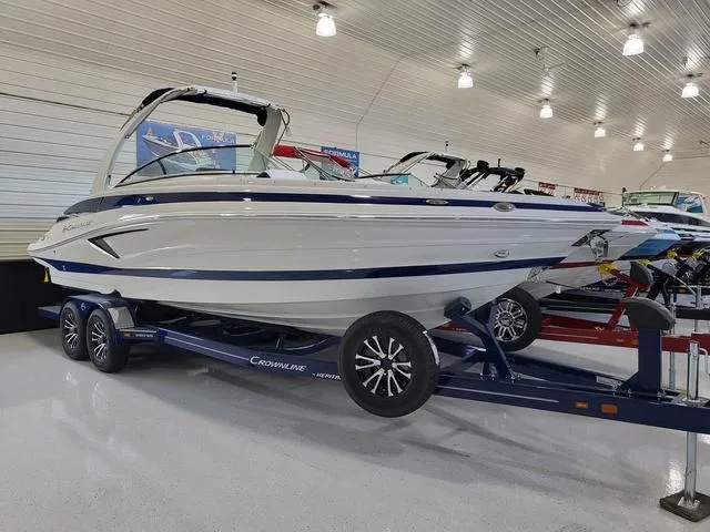 Slide: The Image of 2024 Crownline 280 SS boat on display in a showroom. - 1