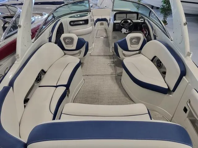 Slide: The Image of 2024 Crownline 280 SS boat interior with blue and white seating, modern dashboard, and spacious layout. - 4