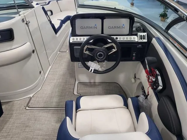 Slide: The Image of 2024 Crownline 280 SS boat cockpit with Garmin navigation, modern steering, and plush seating. - 5
