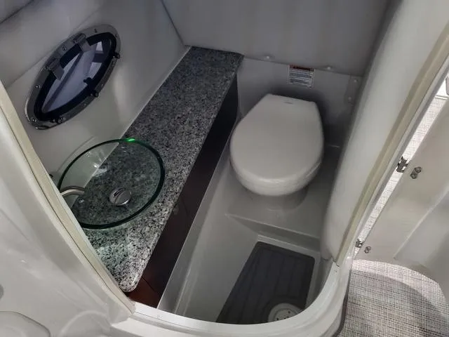 Slide: The Image of 2024 Crownline 280 SS boat bathroom with granite countertop and modern fixtures. - 6