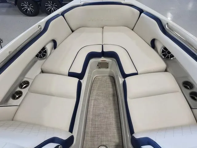 Slide: The Image of 2024 Crownline 280 SS boat interior with white and blue cushioned seating. - 7