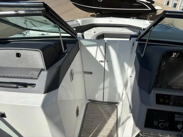 Slide: The Image of 2021 Cobalt R8 boat interior with open windshield and sleek design. - 15