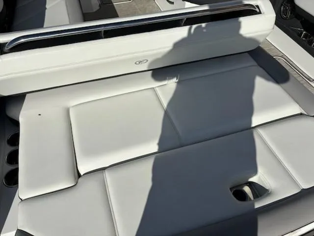 Slide: The Image of 2021 Cobalt R8 boat interior with white cushioned seating and shadow. - 16