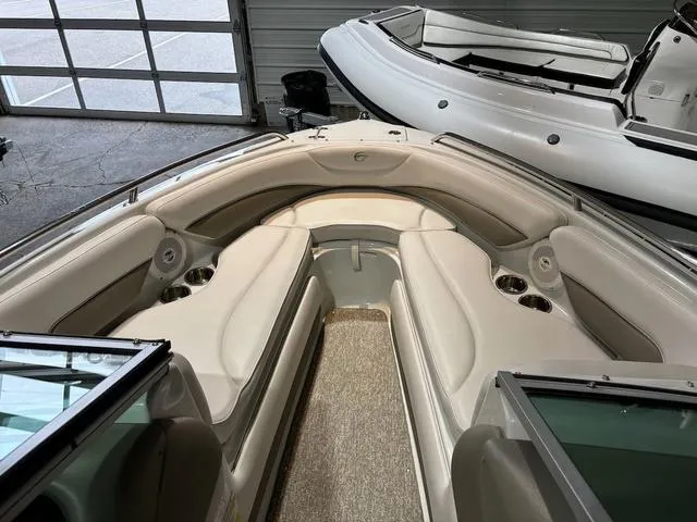 Slide: The Image of 2016 Crownline 21 SS boat interior with beige seating and cup holders. - 10