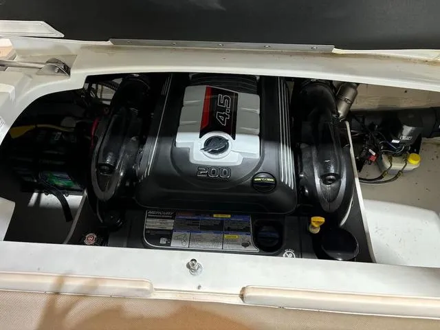 Slide: The Image of Engine compartment of a 2016 Crownline 21 SS boat, featuring a 4.5L Mercury engine. - 12