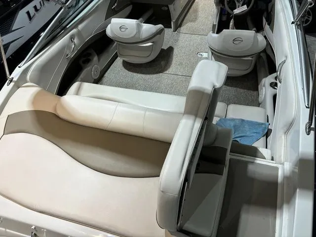 Slide: The Image of 2016 Crownline 21 SS boat interior with beige seating and carpeted floor. - 5