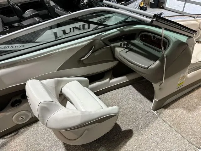 Slide: The Image of 2016 Crownline 21 SS boat interior with gray seating and dashboard. - 7