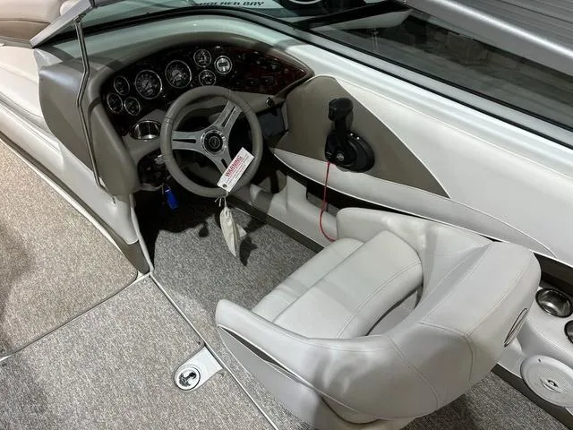 Slide: The Image of 2016 Crownline 21 SS boat interior with steering wheel and dashboard controls. - 8