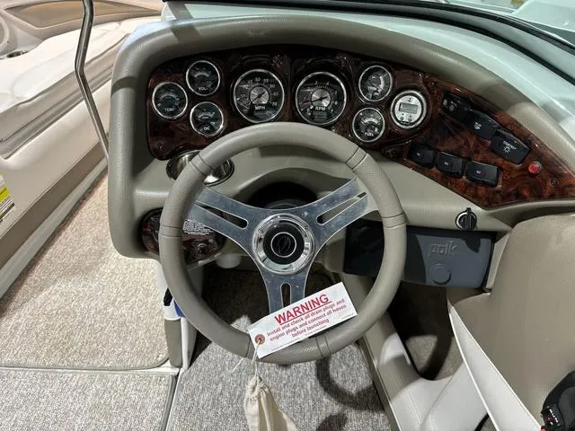 Slide: The Image of 2016 Crownline 21 SS boat dashboard with steering wheel and instrument panel. - 9