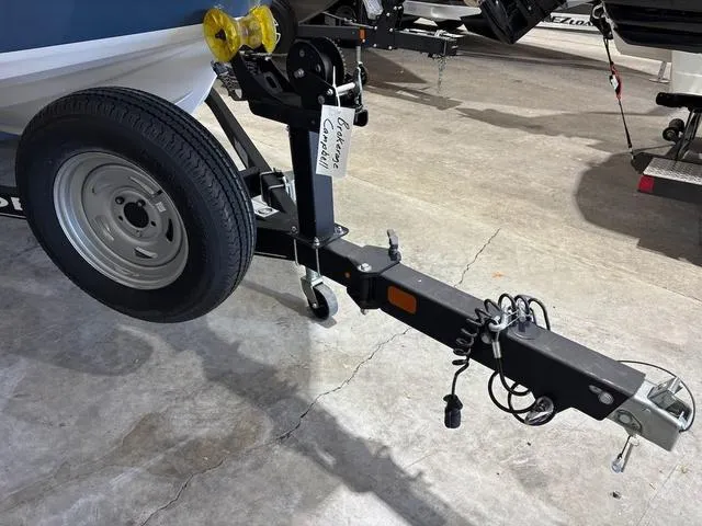 Slide: The Image of Trailer hitch of a 2021 Tahoe 450 TF boat in a garage setting. - 11