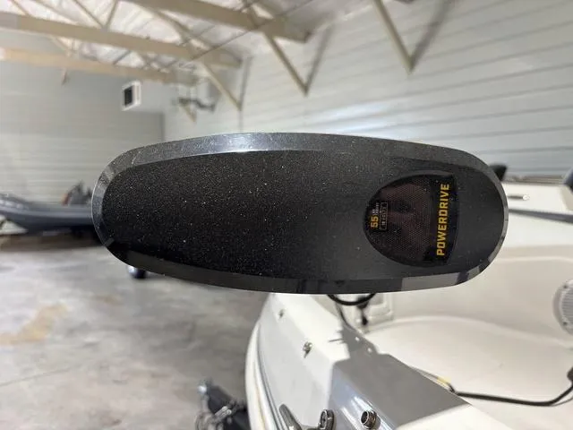 Slide: The Image of 2021 Tahoe 450 TF boat with PowerDrive motor in a garage setting. - 13