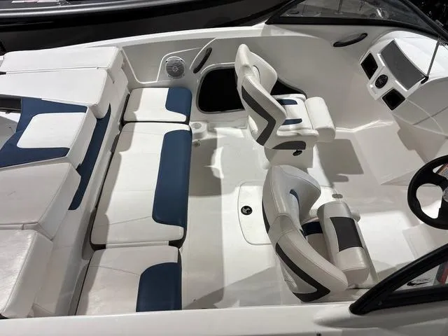 Slide: The Image of Interior of a 2021 Tahoe 450 TF boat with white and blue seating. - 6