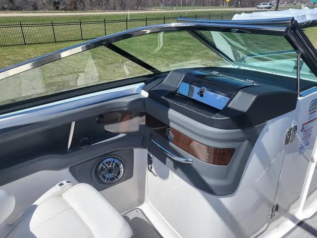 Slide: The Image of 2022 Chaparral 28 Surf boat interior with sleek dashboard and modern design. - 14