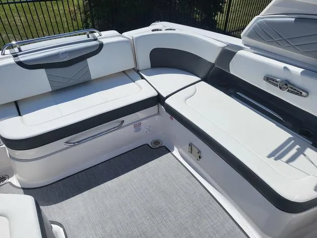Slide: The Image of 2022 Chaparral 28 Surf boat interior with white and gray seating, modern design. - 15
