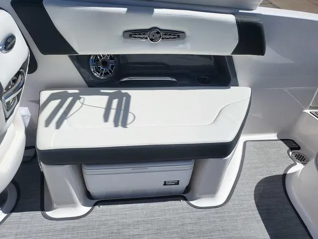 Slide: The Image of 2022 Chaparral 28 Surf boat interior with cushioned seating and integrated speaker. - 16