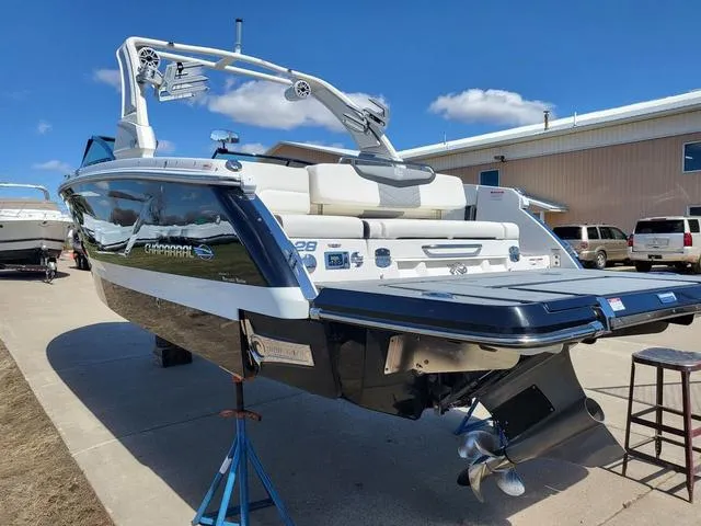Slide: The Image of 2022 Chaparral 28 Surf boat on display outdoors, showcasing sleek design and modern features. - 3