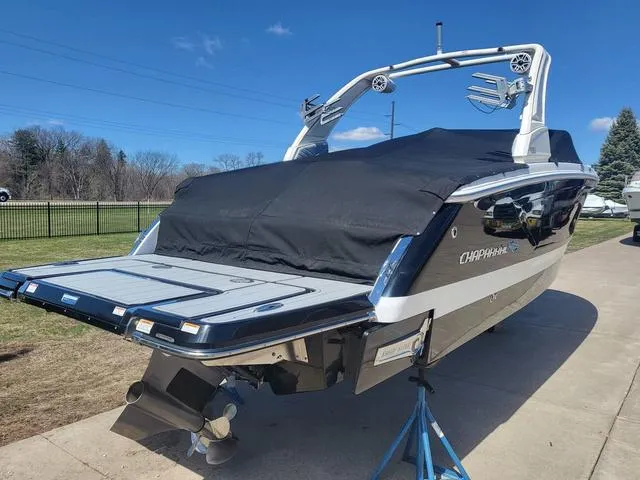 Slide: The Image of 2022 Chaparral 28 Surf boat with cover, parked on a sunny day. - 8