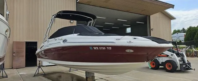 Slide: The Image of 2006 Sea Ray 270 Sundeck boat in storage facility, red and white exterior. - 3
