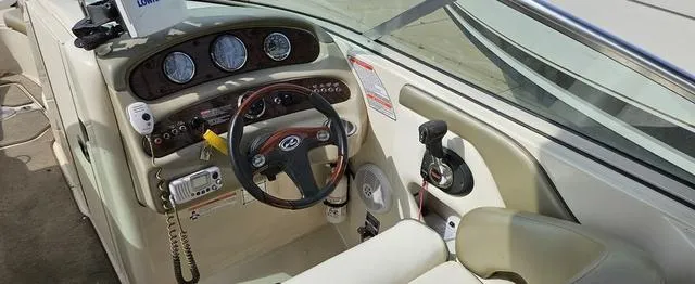 Slide: The Image of 2006 Sea Ray 270 Sundeck boat cockpit with steering wheel and control panel. - 7