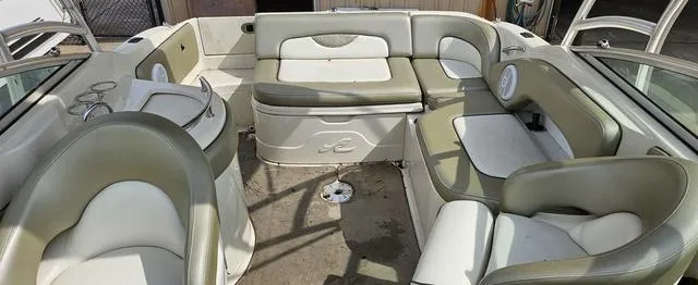 Slide: The Image of 2006 Sea Ray 270 Sundeck interior with spacious seating and cup holders. - 9