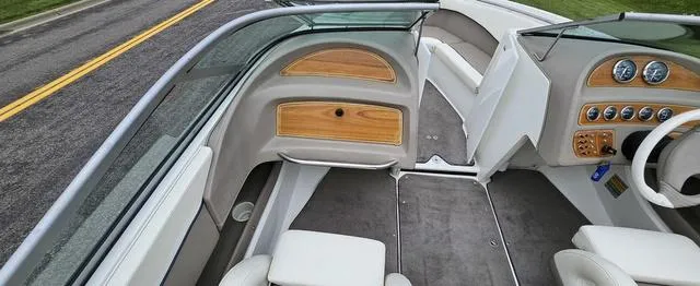 Slide: The Image of 1998 Cobalt 200BR boat interior with wood accents and gray upholstery. - 5