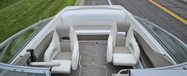 Slide: The Image of 1998 Cobalt 200BR boat interior with white and beige seating, viewed from above. - 7