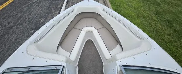 Slide: The Image of 1998 Cobalt 200BR boat bow seating area with white and beige upholstery. - 9