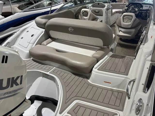 Slide: The Image of 2019 Crownline E 215 XS boat interior with seating and Suzuki engine. - 5