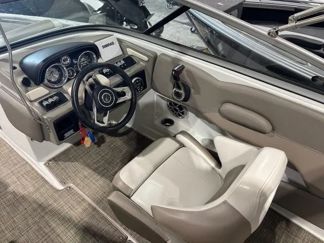 Slide: The Image of 2019 Crownline E 215 XS boat cockpit with steering wheel and dashboard controls. - 7